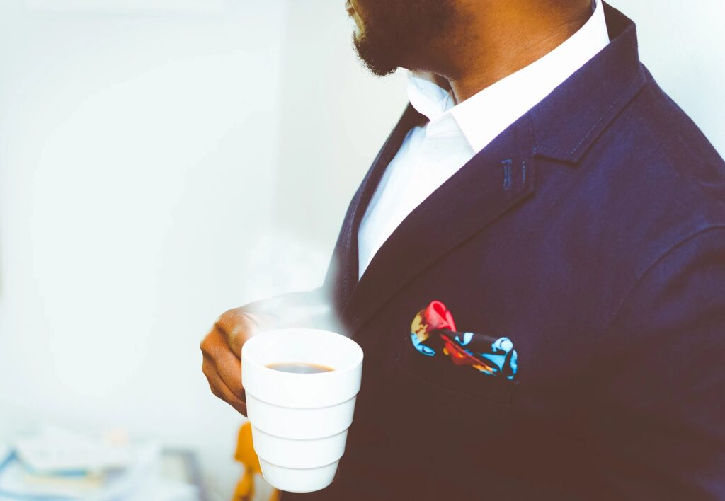 A business man with a cop of coffee.