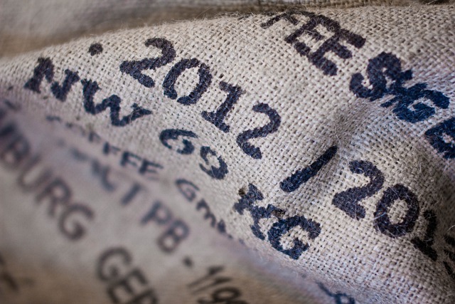 A close up of a canvas messenger bag with writing on it.