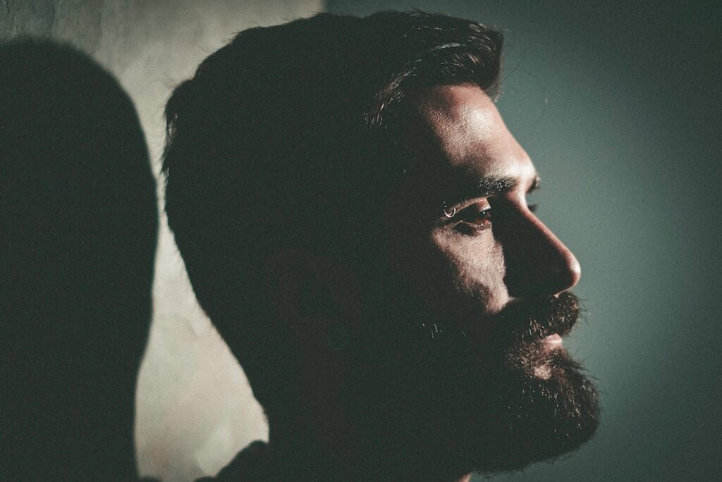 A man with a beard showcasing the best leather bags for men.