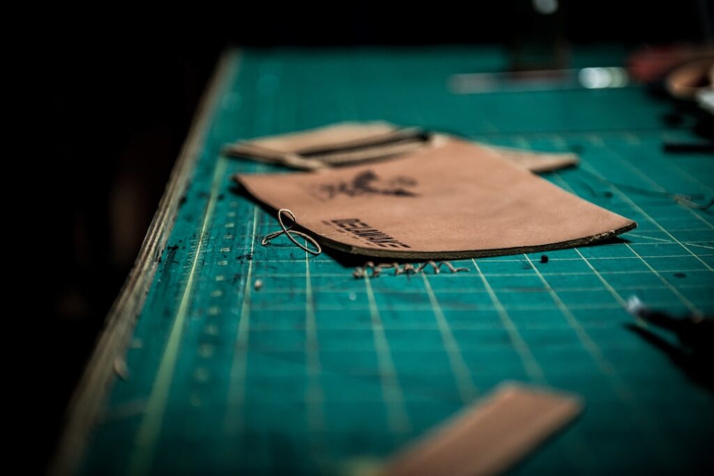 A leather wallet displayed on a cutting board, showcasing leather craftsmanship.