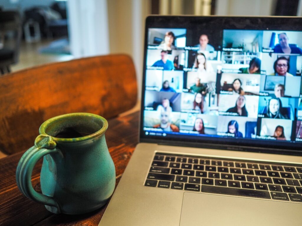 A perfect laptop with a group of people on it on a table.