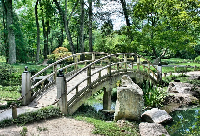 An outstanding wooden bridge over a pond in a Japanese garden.