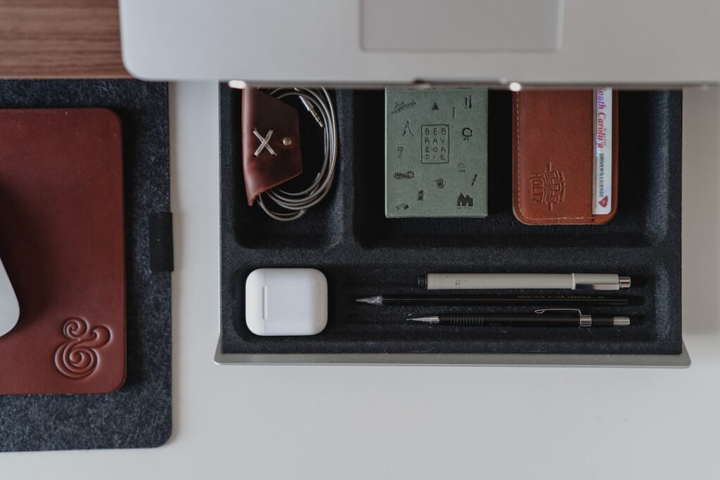 A desk with the best mouse, pens, and other items.