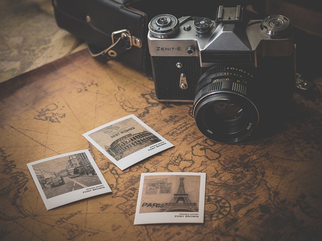 A vintage Zenit-E camera rests on a map with three Polaroid photos of the Roman Colosseum, Eiffel Tower, and Paris street—a chic nod to retro travel vogue.