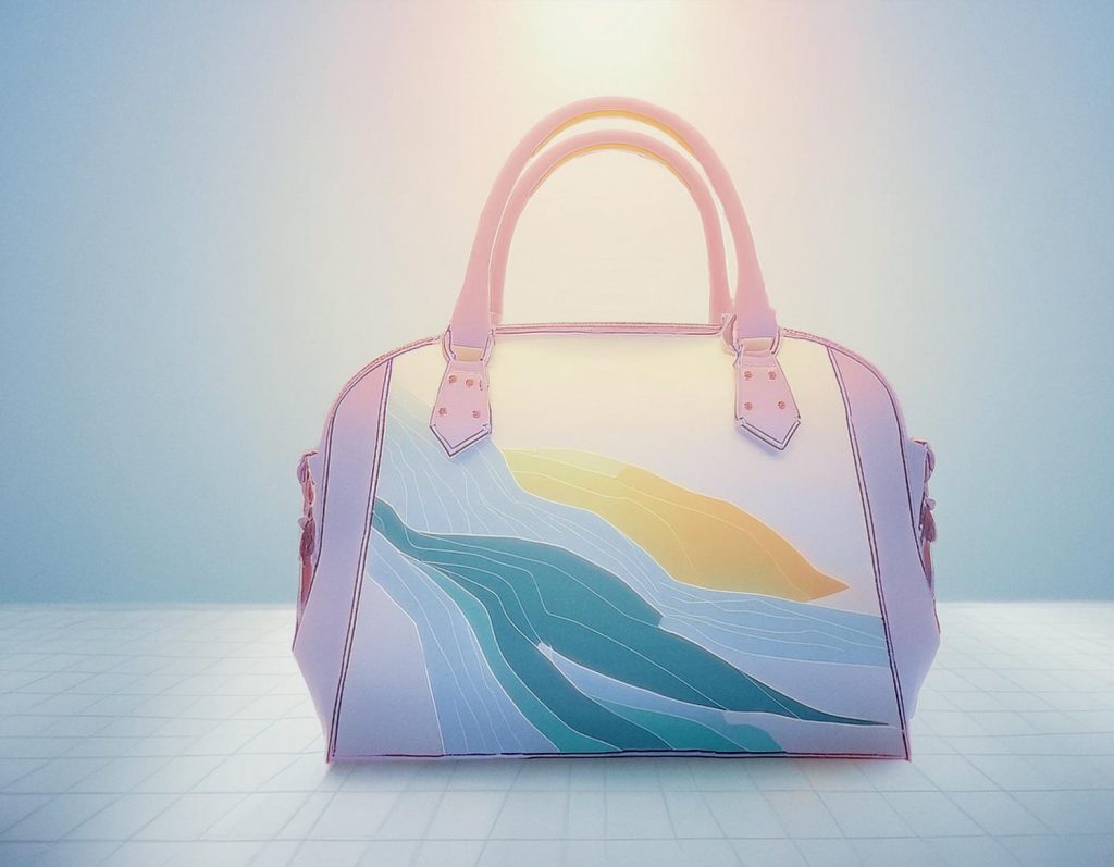 Chic shoulder bag against a gradient backdrop, featuring a vibrant abstract design in soft greens, blues, and yellows with leather straps and metal accents.