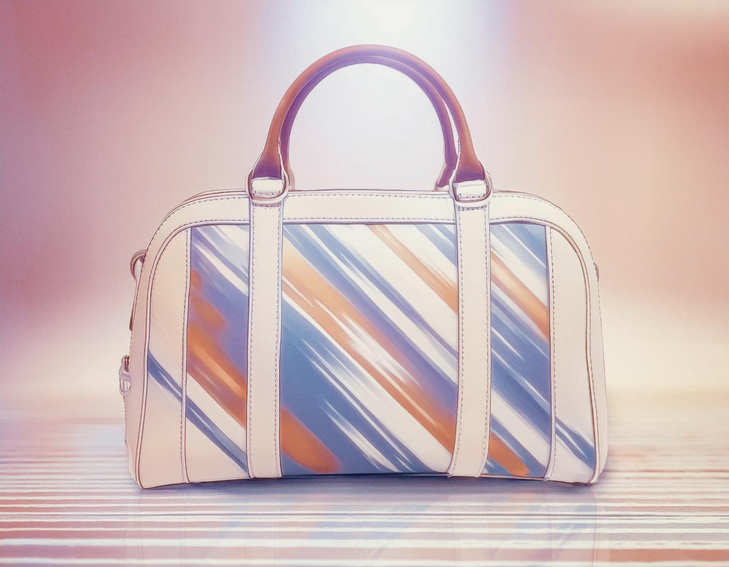 A chic shoulder bag with a brown handle, featuring blue, orange, and white diagonal stripes. Set against a pastel gradient backdrop, this stylish accessory shines on a reflective surface, elevating any modern wardrobe.