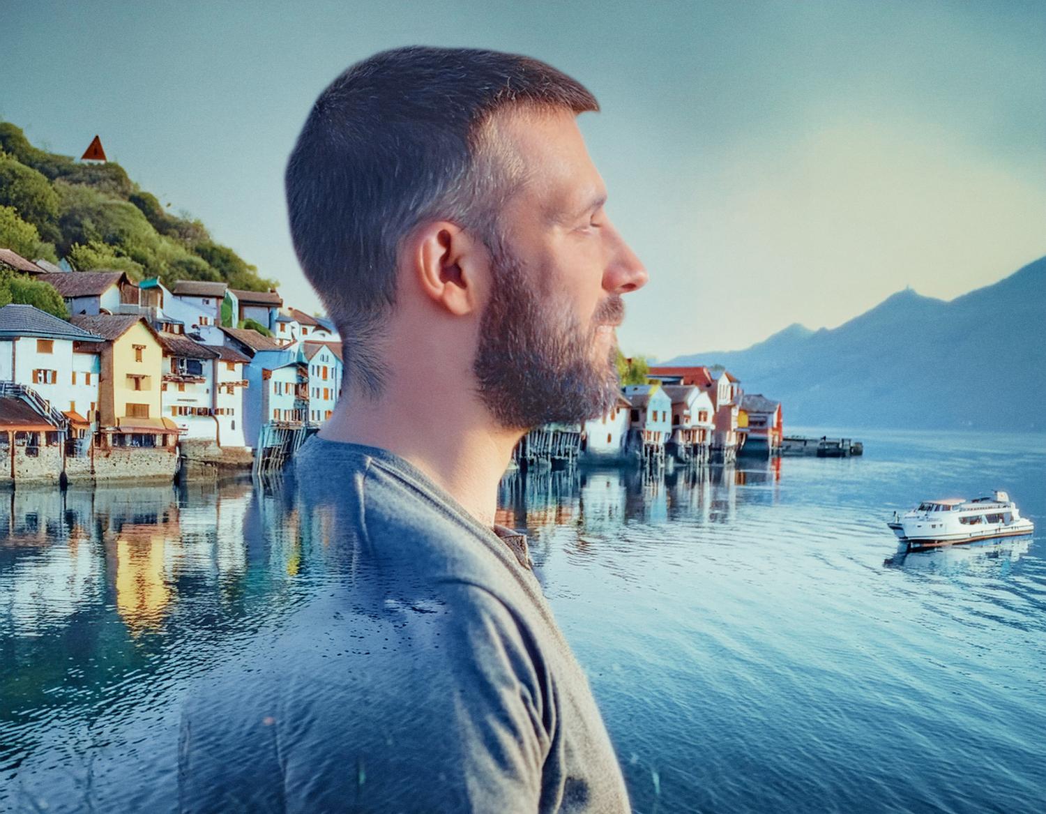 Double exposure reveals a bearded urbanite merging with a coastal village—colorful homes, serene waters, and timeless style meet modern appeal.